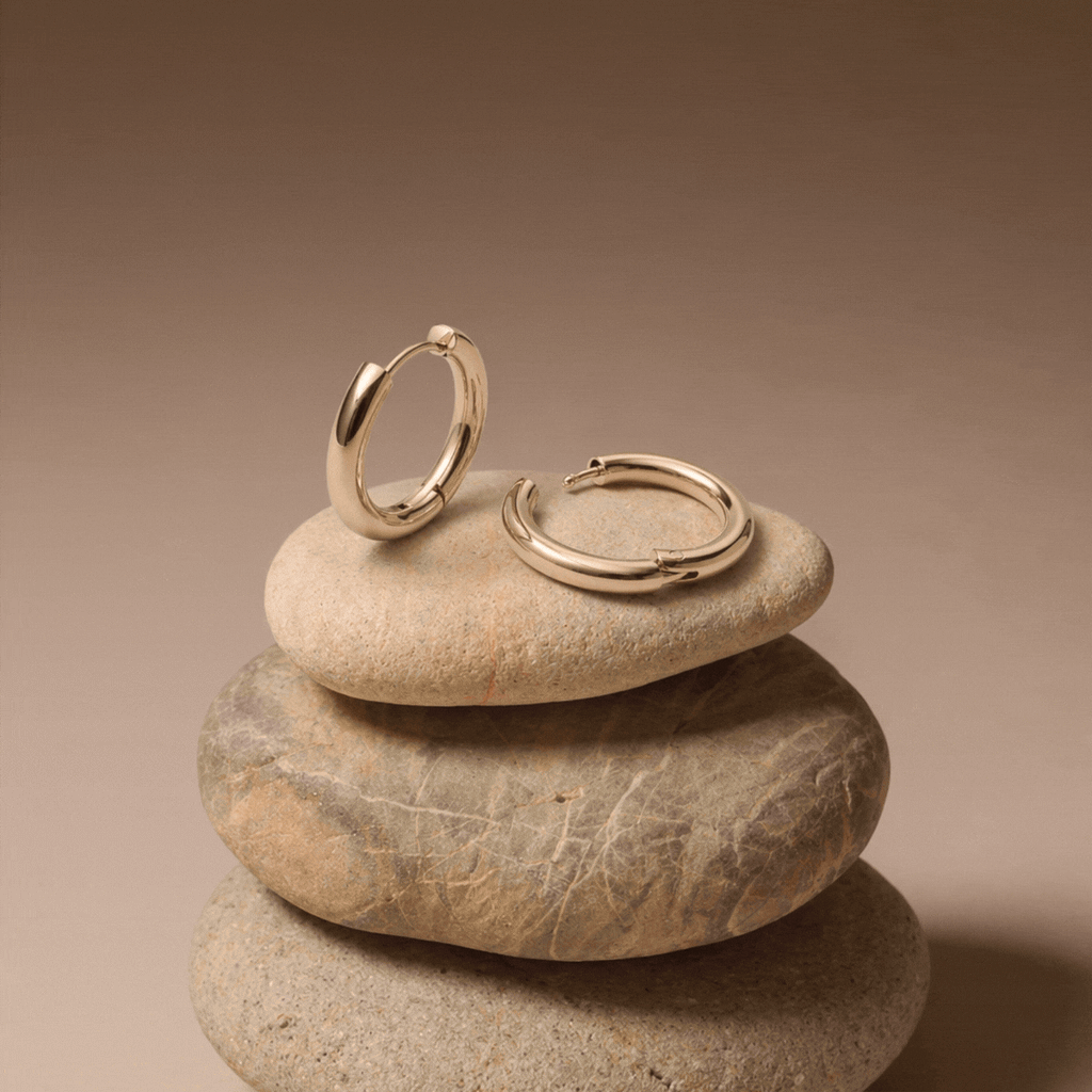 14K Gold Classic Hoop Earrings On Stone Display Close Up